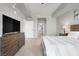 Spacious bedroom with a modern bed, large dresser, and open access to the adjacent bathroom at 8255 Las Vegas Blvd # 722, Las Vegas, NV 89123