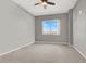 Minimalist bedroom showcasing neutral paint and carpet plus large window providing natural light at 8255 Las Vegas Blvd # 722, Las Vegas, NV 89123