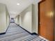 Long hallway with blue and beige striped carpet leading to a door at 8255 Las Vegas Blvd # 722, Las Vegas, NV 89123