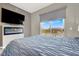 Stylish main bedroom showcasing an electric fireplace, scenic view, and comfortable modern design at 8255 Las Vegas Blvd # 722, Las Vegas, NV 89123