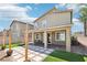 Well-manicured backyard featuring a covered patio with string lights, artificial grass, and a desert landscape at 9238 Bluemist Falls St, Las Vegas, NV 89123