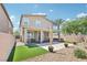 Spacious backyard with patio, desert landscape, and artificial grass, perfect for outdoor living at 9238 Bluemist Falls St, Las Vegas, NV 89123