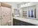 Bathroom featuring double sinks, granite countertops, and a shower-tub combo at 9238 Bluemist Falls St, Las Vegas, NV 89123