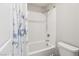 Clean white bathroom with a tiled shower-tub and modern fixtures at 9238 Bluemist Falls St, Las Vegas, NV 89123