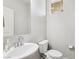 Clean half bath with a white vessel sink, modern faucet, toilet, and small window at 9238 Bluemist Falls St, Las Vegas, NV 89123