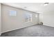 Spacious room features plush gray carpet, neutral walls, recessed lighting, and natural light at 9238 Bluemist Falls St, Las Vegas, NV 89123
