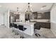 Open-concept kitchen featuring a large island, stainless appliances, and modern gray cabinets at 9238 Bluemist Falls St, Las Vegas, NV 89123
