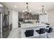 Modern kitchen features stainless steel appliances, granite countertops, and a large center island with bar seating at 9238 Bluemist Falls St, Las Vegas, NV 89123
