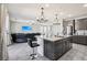 Open-concept kitchen featuring a large island with seating, stainless appliances, and gray cabinets at 9238 Bluemist Falls St, Las Vegas, NV 89123