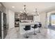 Open-concept kitchen featuring a large island, stainless appliances, and modern pendant lighting at 9238 Bluemist Falls St, Las Vegas, NV 89123