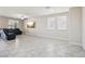 Bright, open-concept living room with neutral tones, tile flooring and lots of natural light at 9238 Bluemist Falls St, Las Vegas, NV 89123