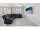 Spacious open-concept living room with neutral tones, tile flooring and a large sectional at 9238 Bluemist Falls St, Las Vegas, NV 89123
