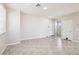 Spacious open-concept living room with neutral tones, tile flooring and lots of natural light at 9238 Bluemist Falls St, Las Vegas, NV 89123