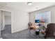 Functional office with neutral walls, two windows with blinds, gray carpet, and ample workspace at 9238 Bluemist Falls St, Las Vegas, NV 89123