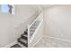 Bright staircase features neutral walls, carpeted stairs, white railings, and natural light from a window at 9238 Bluemist Falls St, Las Vegas, NV 89123