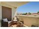 Relaxing outdoor balcony seating with chairs, table, and pleasant neighborhood views at 9303 Gilcrease Ave # 2234, Las Vegas, NV 89149