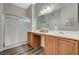 Bathroom featuring a double vanity, a large mirror, and a glass-enclosed shower at 9303 Gilcrease Ave # 2234, Las Vegas, NV 89149