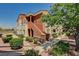 Apartment building showing two-tone stucco, staircases, sidewalks, and landscaping at 9303 Gilcrease Ave # 2234, Las Vegas, NV 89149