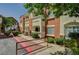 Apartment building featuring stucco, well maintained landscaping, and sidewalk at 9303 Gilcrease Ave # 2234, Las Vegas, NV 89149