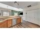 Bright kitchen area with wood cabinets and breakfast bar, open to the living room, and a pantry at 9303 Gilcrease Ave # 2234, Las Vegas, NV 89149