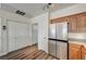 Kitchen with stainless appliances and oak cabinets features large pantry and storage closet for convenience at 9303 Gilcrease Ave # 2234, Las Vegas, NV 89149