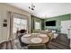Inviting living room features neutral tones, wood-style flooring, a green accent wall, and a cozy dining nook at 9303 Gilcrease Ave # 2234, Las Vegas, NV 89149