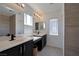 Updated bathroom with double sinks, modern fixtures, and natural stone accents at 9443 Hot Breeze St, Las Vegas, NV 89178