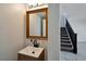 Half bath with wood-framed mirror and tiled floors at 9443 Hot Breeze St, Las Vegas, NV 89178