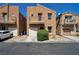 Two-story home with tan stucco, balcony, and front yard landscaping at 9443 Hot Breeze St, Las Vegas, NV 89178