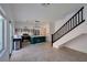Open floorplan kitchen with stainless appliances and staircase access at 9443 Hot Breeze St, Las Vegas, NV 89178