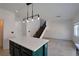 Kitchen island with pendant lighting and view of staircase at 9443 Hot Breeze St, Las Vegas, NV 89178