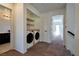 Hallway laundry area with stacked washer and dryer and built in shelving at 9443 Hot Breeze St, Las Vegas, NV 89178