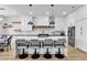 Modern kitchen featuring white cabinets, a quartz countertop island with seating, and stainless steel appliances at 9513 Villa Ridge Dr, Las Vegas, NV 89134