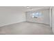 Spacious, carpeted bedroom features a large window, offering a blank canvas ready for personalized decor and furnishings at 9742 Toad Hollow St, Las Vegas, NV 89141