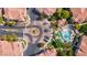 Aerial view showcasing the community's layout, featuring a roundabout, pool and common areas at 9975 Peace Way # 2009, Las Vegas, NV 89147