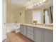 Bathroom with double sink vanity, granite countertop, and neutral colored tile flooring at 9975 Peace Way # 2009, Las Vegas, NV 89147