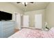 Bedroom with a ceiling fan, dresser, and multiple closet doors for ample storage space at 9975 Peace Way # 2009, Las Vegas, NV 89147