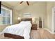 Bright bedroom with a wooden bed frame, large window, and light hardwood floors at 9975 Peace Way # 2009, Las Vegas, NV 89147