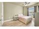 Cozy bedroom featuring wood-look flooring, ceiling fan, and a comfortable bed at 9975 Peace Way # 2009, Las Vegas, NV 89147