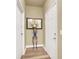 Bright entryway featuring wood-look floors, decorative mirror, and access to additional rooms at 9975 Peace Way # 2009, Las Vegas, NV 89147
