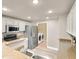 Well-lit kitchen with stainless steel appliances, granite counters, and an adjacent laundry area at 9975 Peace Way # 2009, Las Vegas, NV 89147