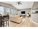 Open-concept living room featuring wood floors, vaulted ceiling, and comfortable seating at 9975 Peace Way # 2009, Las Vegas, NV 89147