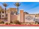 Chateau Nouveau community sign featuring stacked stone and stucco with palm trees at 9975 Peace Way # 2009, Las Vegas, NV 89147