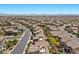 High-angle view of an expansive neighborhood featuring well-maintained homes with pools and landscaping, and a curving street pattern at 12269 Catanzaro Ave, Las Vegas, NV 89138