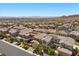 Elevated neighborhood view reveals uniform homes with landscaped yards, extending across a level terrain toward distant mountains at 12269 Catanzaro Ave, Las Vegas, NV 89138