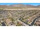 Aerial neighborhood view of rows of houses surrounded by desert landscaping and mountain views at 12269 Catanzaro Ave, Las Vegas, NV 89138