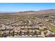 An aerial shot displays a densely populated residential neighborhood with similar architecture and mountain views at 12269 Catanzaro Ave, Las Vegas, NV 89138