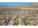 Aerial neighborhood view of rows of houses surrounded by desert landscaping and mountain views at 12269 Catanzaro Ave, Las Vegas, NV 89138