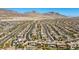 Panoramic aerial shot of a large residential development with uniform rooftops and a backdrop of desert landscape under a clear sky at 12269 Catanzaro Ave, Las Vegas, NV 89138