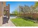 This backyard features a well-manicured lawn, lush landscaping, and a patio leading to the pool area at 12269 Catanzaro Ave, Las Vegas, NV 89138